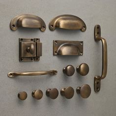 an assortment of door handles and knobs on a gray surface