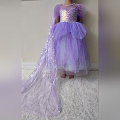 "Newwith Tag" Transform Your Little One Into A Dazzling Princess With Our Magical Lavender Princess Dress. This Enchanting Dress Features A Heart-Shaped Sequined Bodice That Shimmers With Every Move. The Dreamy Lavender Tulle Skirt Is Adorned With Glittery Castle And Firework Designs, Making It Perfect For Playtime, Special Occasions, Or Dress-Up Parties. Festive Princess Tutu Dress For Dress-up, Festive Princess Style Tulle Dress, Purple Tulle Dress For Dress-up, Lavender Tulle Princess Dress For Dress-up, Lavender Princess Dress For Dress-up, Princess Style Lavender Fairy Dress For Party, Lavender Princess Dress For Party, Lavender Princess Dress For Dress-up Occasions, Festive Princess Dress