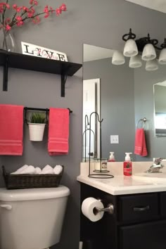 a white toilet sitting under a bathroom mirror next to a sink and a bath tub