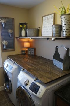 a washer and dryer are sitting on the counter in this small laundry room