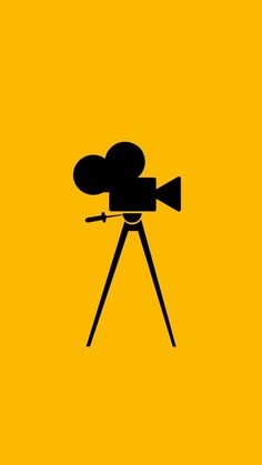 an old movie camera on a tripod silhouetted against a bright yellow background with the word'film'written below it