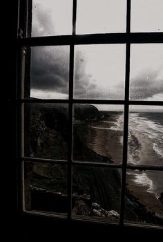 an open window looking out at the beach