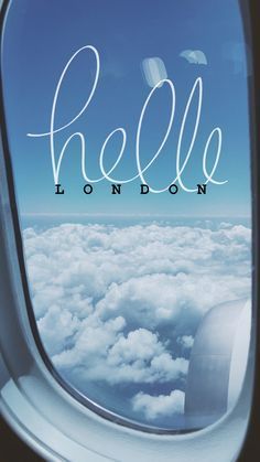 an airplane window with the words helle london written on it's side and clouds below