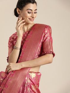 Pink and Gold-toned banarasi woven design saree and has a zari borderThe model is wearing a stitched version of the blouse piece. The saree comes with an unstitched blouse piece Banarasi sarees originate from the city of Varanasi (Uttar Pradesh). These are well known for the Mughal Era inspired designs in golden as well as silver brocade or Zari. Zari work is known for the art of weaving threads in golden and silver colours. It involves the process of twisting a flattened metallic strip, which s Western Kurtis, Saree Sale, Design Saree, Banarasi Saree, Soft Silk Sarees, Uttar Pradesh, Varanasi, Woven Design, Banarasi Sarees