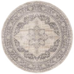 a round rug with an ornate design in grey and beige colors on a white background