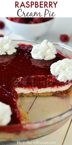 raspberry cream pie with whipped cream on top in a glass pie dish, ready to be eaten