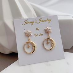 * DETAILS * - 18K Gold Plated Moon with tiny star Charm 12*19mm - 18K Gold Plated Star Post Earrings ✨more earrings. www.Etsy.com/shop/JinnysJewelryBySeJin * CARE TIPS * ⭐️TO PREVENT TARNISH: Keep your jewelry in airtight plastic bags. It won't tarnish if it isn't exposed to air. The worst place to leave your jewellery is in a steamy bathroom. Wipe with a soft cloth after wearing. - Perfumes: Be sure any perfume or lotions are completely absorbed into skin. - Hair products: Apply all hair produc Gold Celestial Round Earrings, Celestial Gold Round Earrings, Gold Single Moon-shaped Earring, Gold Crescent Earrings For Anniversary, Rose Gold Celestial Earrings For Gift, Gold Moon Charm Drop Earrings, Gift Moon Charm Round Earrings, Gold Moon Shaped Earrings For Gift, Gold Moon-shaped Earrings For Gift