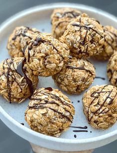 a white bowl filled with cookies covered in chocolate