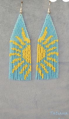 two pairs of beaded earrings with yellow and blue beads on them, one is shaped like a house