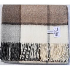 a brown and white plaid blanket with a tag on it