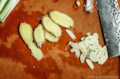 chopped up onions on a cutting board next to a knife and some other food items