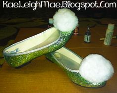 two pairs of green and white slippers sitting on top of a wooden table