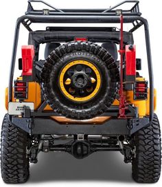 the rear end of a yellow and black jeep with its tire guards on it's tires