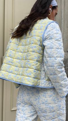 Made from recycled fabric, our lightweight Amelia Quilted Jacket features a colorblock design of our original toile floral prints. Designed as a convertible piece, the Amelia Jacket can be worn as-is or turned into a vest by removing the sleeves. Butter yellow and off-white base with baby blue florals Soft matte quilted fabric Removable sleeves and functional front pockets Lightweight warmth Made from recycled poly Your order will ship from our warehouse in Florida, USA! Casual Floral Patchwork Outerwear For Spring, Spring Patchwork Outerwear, Blue Quilted Spring Outerwear, Spring Nylon Outerwear With Patchwork, Quilted Cotton Outerwear For Spring, Spring Cotton Quilted Outerwear, Spring Quilted Cotton Outerwear, Blue Patchwork Outerwear For Spring, Fitted Nylon Spring Outerwear