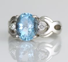 an oval blue topaz ring with diamond accents