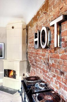 an old brick wall with the word hot on it and two turntables in front