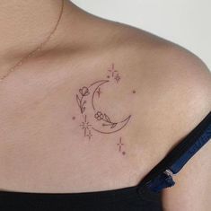 a woman with a tattoo on her shoulder that has the moon and stars in it