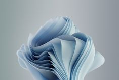 an abstract image of blue paper folded in the shape of a flower on a gray background