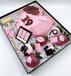 a pink cake in a box with some decorations