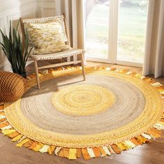 a living room area with a chair and rug on the floor next to a window