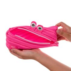 Brighten your day with ZIPIT's playful pencil case, designed to add a touch of fun to your daily routine. Featuring bright eyes and a toothy grin, this unique pencil pouch is made from one long zipper, making it as clever as it is charming. The spacious interior provides plenty of room for all your essentials, keeping you organized in a whimsical way. With its big personality and practical design, the ZIPIT Monster Pouch is perfect for storing a variety of items. The extra-wide opening ensures y Pink Pencil-shaped Case With Zipper Closure, Pink Pencil-shaped Pencil Case With Zipper, Pink Pencil Case With Zipper Pocket For Personal Use, Kawaii Pencil Case With Zipper Closure, Cute Pink Pencil Case With Zipper Closure, Pink Playful Pouch Pencil Case, Fun Pink Pencil Case For School, Playful Pink Portable Pencil Case, Cute Pencil Case With Zipper Closure For Daily Use