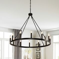 a chandelier with candles hanging from it's center piece in a dining room