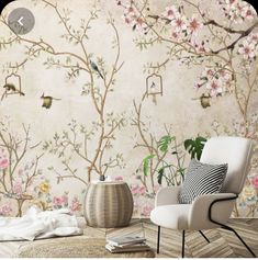 a living room with floral wallpaper and white chair in front of the table,