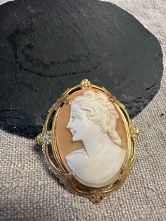 "A Vintage brooch- lovely hand carved shell Cameo of a beauty.  Condition I see no problems, safety catch works, Size approx. 1 5/8\" by almost 1 1/2\".  A Classic jewelry design." Vintage Gold Intaglio Brooches, Ornate Carved Gold Brooches, Ornate Gold Carved Brooches, Vintage Gold Carved Brooches, Collectible Carved Gold Brooches, Antique Gold Cameo Brooches, Antique Gold Cameo Brooch, Vintage Cameo Brooch In Yellow Gold, Vintage Yellow Gold Cameo Brooch