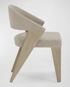 an upholstered chair with wooden legs and a seat made out of plywood