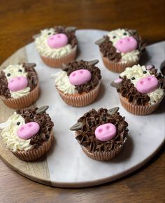 cupcakes decorated with frosting and pink noses on a plate