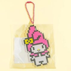 a plastic bag with a hello kitty keychain hanging from it's side