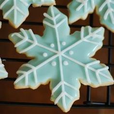 some frosted cookies with icing on top of each other in the shape of a snowflake