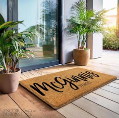 a welcome mat on the floor with potted plants