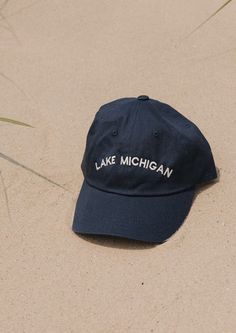 This Lake Michigan "Dad Hat" is a classic. The vintage denim color is sure to match every outfit all year round. Embroidered locally in Grand Rapids. Regular fit 100% Cotton Hand wash Casual Cotton Hat For Fall, Vintage Cotton Baseball Cap For Summer, Vintage Cotton Dad Hat One Size, Outdoor Cotton Hat With Embroidered Logo, Vintage Cotton Dad Hat One Size Fits Most, Vintage Cotton Hat With Letter Print, Casual Embroidered Hats For Outdoor, Navy Casual Hat For Fall, Navy Casual Fall Hats