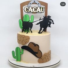 a three tiered cake decorated with cowboy decorations