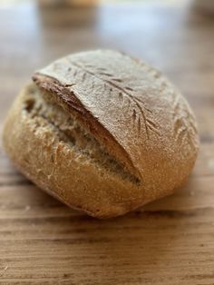 a loaf of bread sitting on top of a wooden table