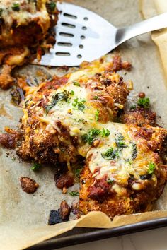 a close up of food on a tray with a spatula