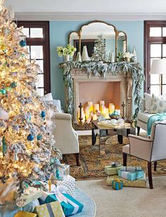 a living room decorated for christmas with blue and gold decorations on the fireplace mantel