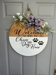 a welcome sign on the front door of a house with a dog's paw