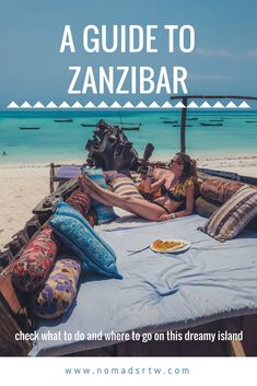 a woman laying on top of a bed next to the ocean with text overlay reading a guide to zanibar check what to do and where to go on this dream island