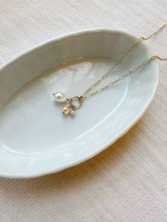 This mixed Freshwater Pearl necklace makes a gorgeous and unique addition to your necklace stack! The dainty chain is accented with 3 unique genuine Pearls of varying shapes and sizes. This makes a beautiful and dainty gift for your special someone! Details: * 14K Gold Filled chain and dainty spring clasp * 18"+2" extender length * Pink and white Freshwater Pearls Shop all Pearl Jewelry here!: https://etsy.me/3zMbXyh GET TO KNOW MAGBEE JEWELRY! ✨  🤍 All MagBee pieces are safe for sensitive skin 14k Gold Filled Pearl Chain Jewelry For Anniversary, Dainty Pearl Necklace For Everyday, Delicate 14k Gold Filled Charm Necklace For Anniversary, Heirloom Dangle Jewelry For Gifts, Heirloom Pendant Necklaces With Lobster Clasp, Heirloom Pendant Necklace With Lobster Clasp, Delicate Pendant Jewelry With Lobster Clasp, Dainty Charm Necklace With Pearl Chain And Round Pendant, Dainty Pearl Charm Necklace In 14k Gold