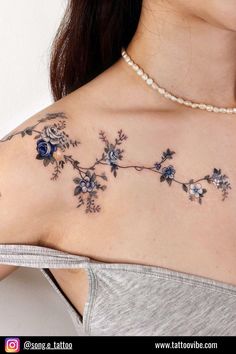 a woman's chest with blue flowers on it