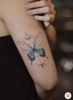 a woman with a butterfly tattoo on her arm