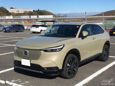 a beige suv parked in a parking lot