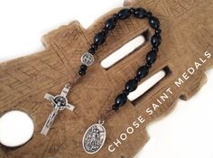 "Hand crafted wooden pocket rosary made with black wooden beads,little black wooden spacer beads,one silver tone 1cm saint medal on Our father bead,Saint medal 0,9\" and silver tone St.Benedict cross. Make it personal by choosing your medals. Metal parts made in Italy. A nice gift for a loved one or a statement of faith to wear yourself. For more similar items and different colors visit our store: https://www.etsy.com/shop/Thelightjewelry?ref=seller-platform-mcnav." One Decade Rosary, Wooden Rosary, St Benedict Cross, Protestant Prayer Beads, Chaplet Rosary, Catholic Bracelet, Mini Rosaries, Pocket Rosary, Personalized Rosary