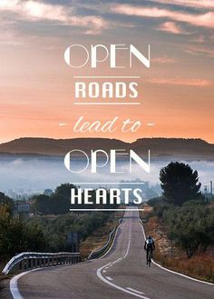 a person riding a bike down a road with the words open roads lead to open hearts