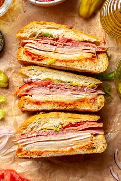 sandwiches with meat, cheese and vegetables on a table