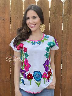 This Beautiful Mexican blouse is full of colorful flowers in both the front and the sleeves that are inspired by Mexican culture. This blouse is embroidered By Mexican Artisans in Chiapas and is completely one of a kind. Purchase the gold plated filigree earrings here: https://www.etsy.com/es/listing/869865239/filigrana-de-corazon-filigrana-clasica?ref=listings_manager_grid Summer Multicolor Blouse With Floral Patchwork, Hippie Multicolor Floral Print Tops, Multicolor Floral Print Blouse For Festivals, Folk Style Multicolor Top With Geometric Embroidery, Multicolor Embroidered Printed Summer Blouse, Summer Printed Blouse With Multicolor Embroidery, Multicolor Folk Tops For Cinco De Mayo, Folk Style Multicolor Tops For Cinco De Mayo, Summer Blouse With Multicolor Embroidery And Print