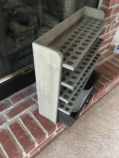 a fire place sitting on the side of a brick building next to a window with glass doors