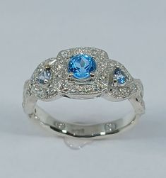 This stunning  style ring has been carefully crafted in 925 solid sterling silver (not silver plated), blue  topaz stone and cubic zirconia.  This beautiful ring would make a great special occasion/birthday gift All of my jewelry is handmade from scratch and of high quality. A tracking shipping number will be provided to you once ring has been mailed. Ring Measurements: Ring is size 7 1/2 but can be resized at no extra cost and will be shipped to you in an elegant gift box. Ring Weight: 3.7 gram Blue Topaz Ring In 14k White Gold, Fine Jewelry Light Blue Diamond Ring With Center Stone, Light Blue Diamond Ring With Center Stone, Fine Jewelry White Gold Sapphire Ring With Blue Topaz, Light Blue Brilliant Cut Fine Jewelry Ring, Light Blue Halo Setting Fine Jewelry, Blue Aquamarine Diamond Ring, Blue Cubic Zirconia Promise Jewelry, Light Blue Sapphire Ring For Anniversary